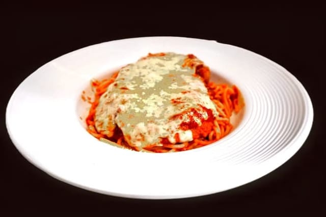 Half Tray Chicken Parmigiana Served with Spaghetti.